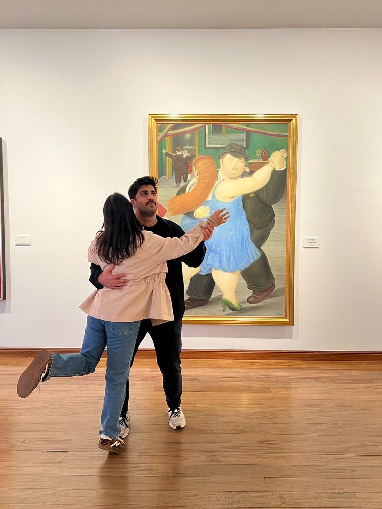 Aman and Ashmeet dancing in a gallery