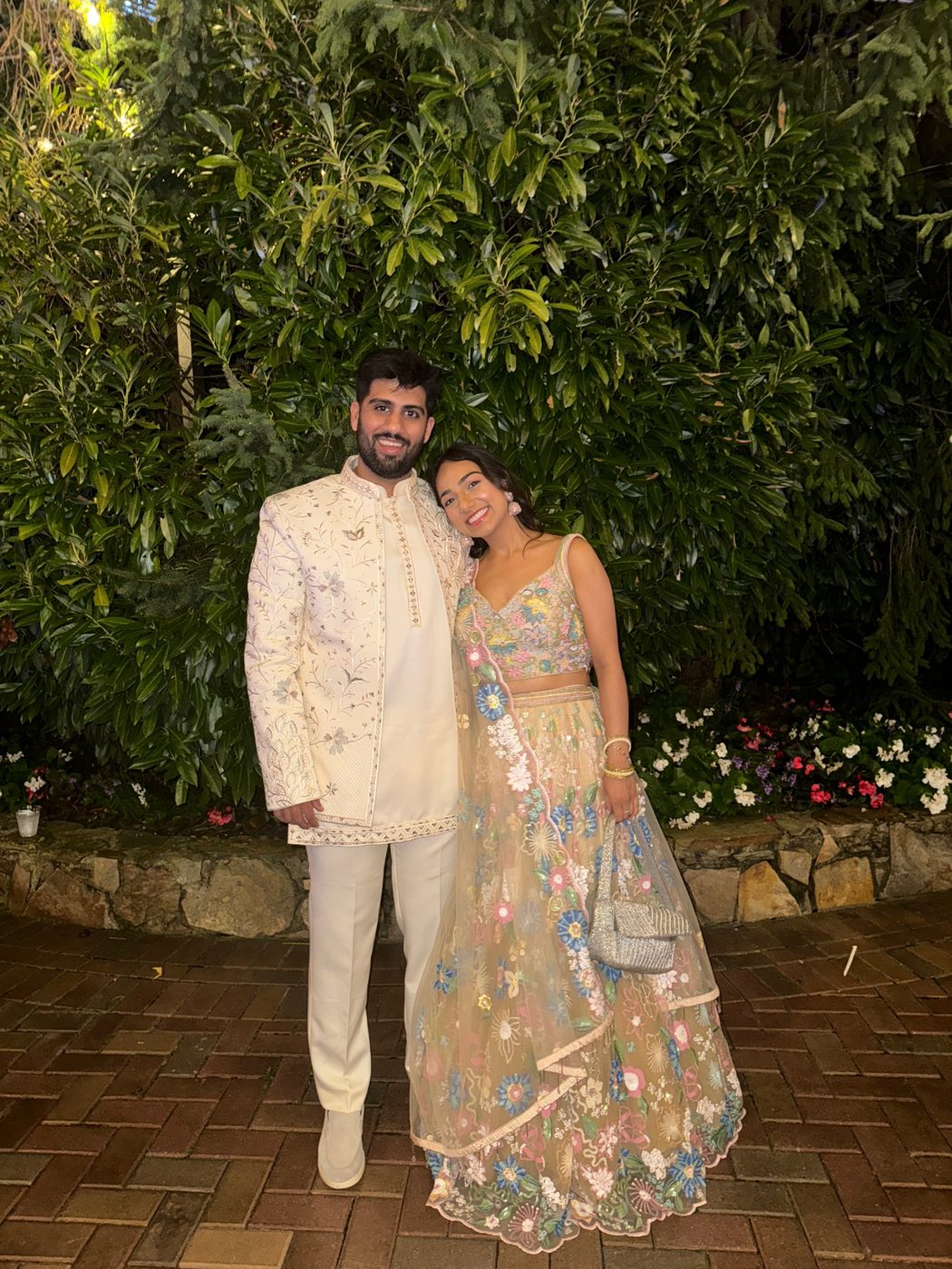 Aman in an ivory sherwani and Ashmeet in a pastel floral lehenga